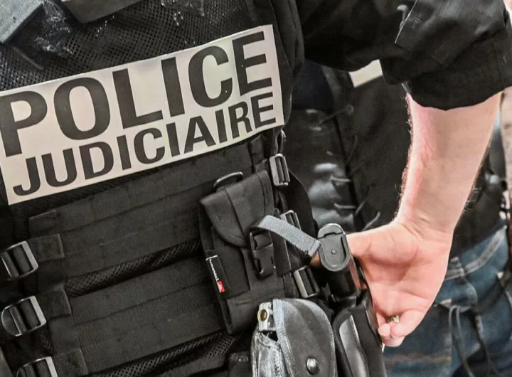 A police officer wearing a bulletproof vest reads "judicial police" stands at the International Cybersecurity Forum (FIC) in Lille, northern France, on September 7, 2021.