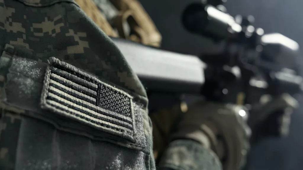 Stripe of American flag on clothes of soldier.