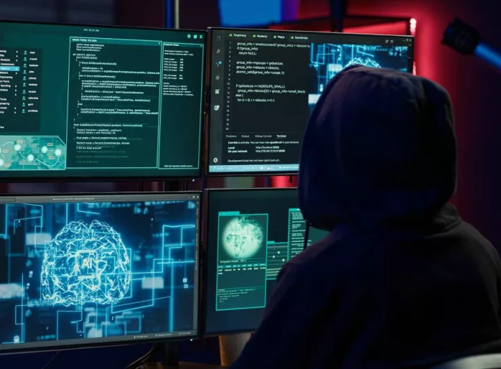 Cybercriminal using AI machine learning to develop zero day exploit undetectable by antivirus software. Hacker using artificial intelligence technology to build script tricking firewalls, camera